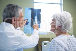 Doctor discussing x-ray report with senior patient