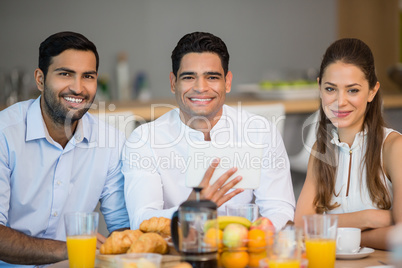 Portrait of smiling business colleagues having breakfast together