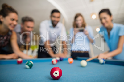 Business colleagues playing pool