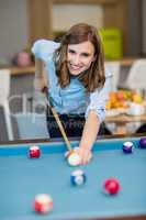 Portrait of smiling business executive playing pool