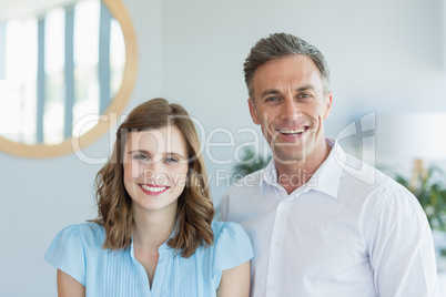 Business executives smiling while standing in office