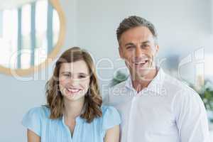 Business executives smiling while standing in office