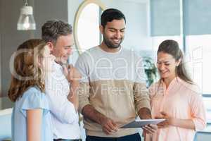 Business executives discussing over digital tablet in office