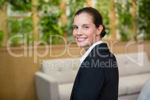 Smiling female business executive sitting in office
