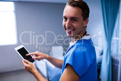 Portrait of doctor using digital tablet in ward