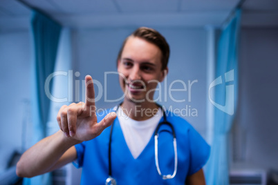 Smiling doctor gesturing in ward