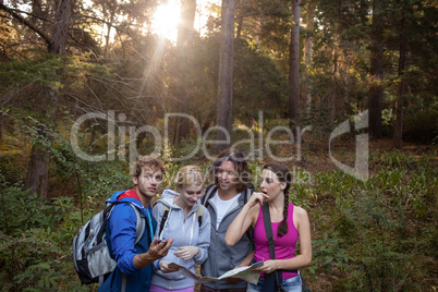 Group of friends looking at the map while hiking