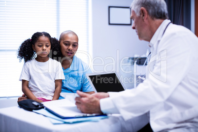 Doctor using digital tablet while interacting with patient