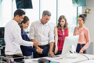 Business colleagues discussing during meeting at desk