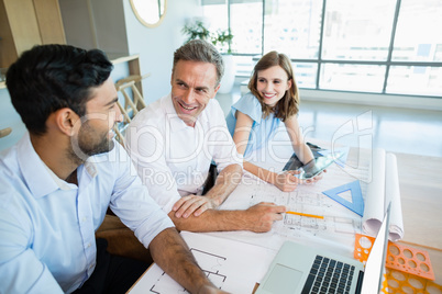 Architects discussing with each other in conference room
