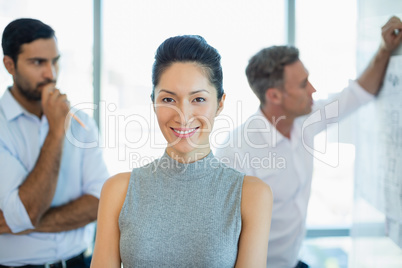 Smiling female architect standing in office