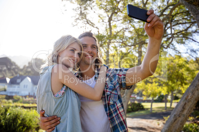 Couple clicking a selfie in park