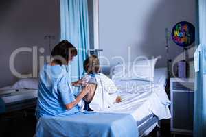 Female doctor examining patient with stethoscope