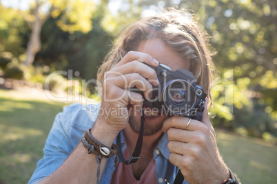 Man taking picture with digital camera
