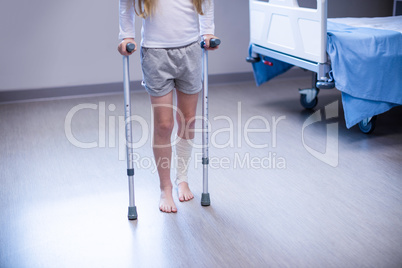 Girl walking with crutches in ward