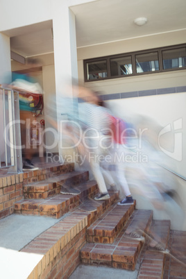 Students moving up staircase at school