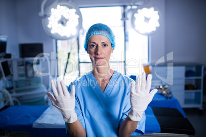 Portrait of female surgeon preparing for operation in operation room