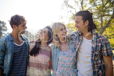 Friends standing together in park