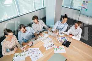 Business executives discussing with each other in conference room