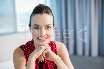 Smiling female business executive sitting in office