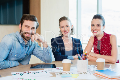 Smiling business executives sitting together in conference room