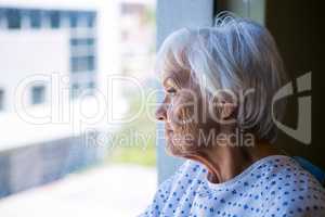 Thoughtful senior patient looking through window