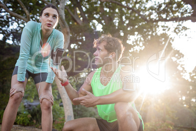 Tired couple relaxing after jogging
