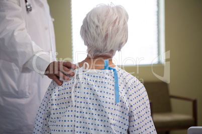 Doctor consoling senior patient