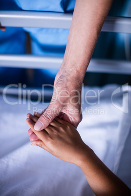 Doctor checking girls hand in the hospital