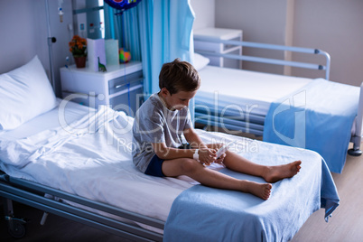 Patient using digital tablet in ward