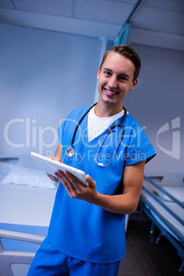 Doctor using digital tablet in ward at hospital