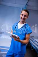Doctor using digital tablet in ward at hospital