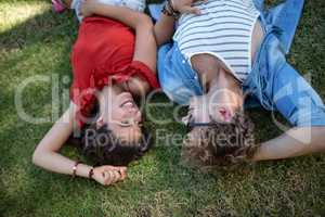 Couple lying on grass in park
