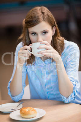 Businesswoman drinking cup of coffee