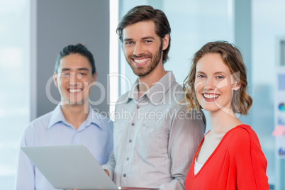 Business executives smiling while standing in office