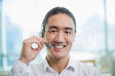 Smiling customer service executive working in call center