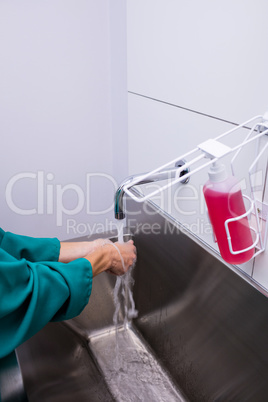 Surgeon washing her hands