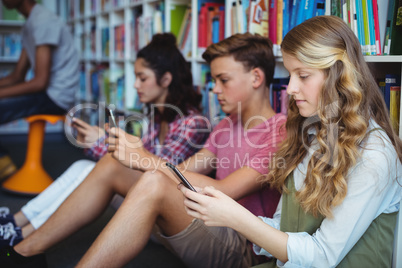 Students using mobile phone in library