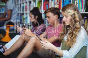 Students using mobile phone in library
