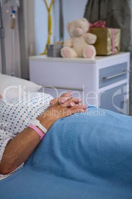 Senior patient lying on bed