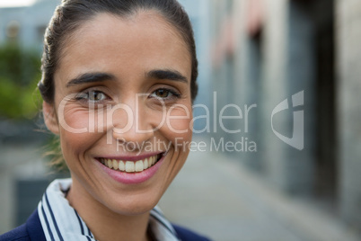 Smiling business executive on city street