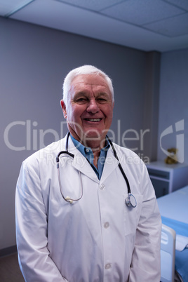 Portrait of male doctor standing in ward