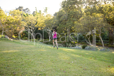 Rear view of female jogger jogging