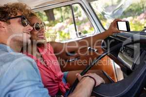 Couple taking a selfie while travelling in campervan