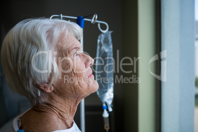 Thoughtful senior patient standing at hospital