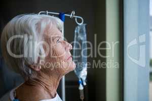 Thoughtful senior patient standing at hospital