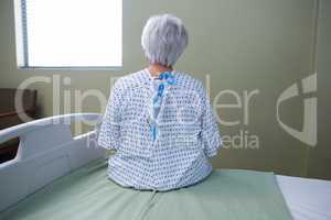 Thoughtful senior patient sitting at hospital