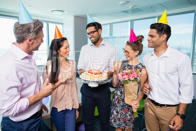 Smiling business colleagues celebrating birthday