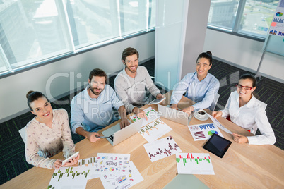 Smiling business executives working in conference room