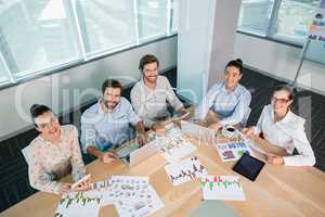 Smiling business executives working in conference room